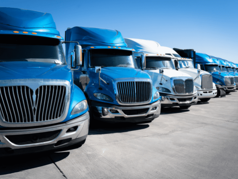 image of Blue and white tractor trailers parked diagonally