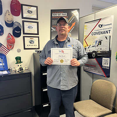 Image of CDS grad, Bobby Reynolds, posing with his certificate
