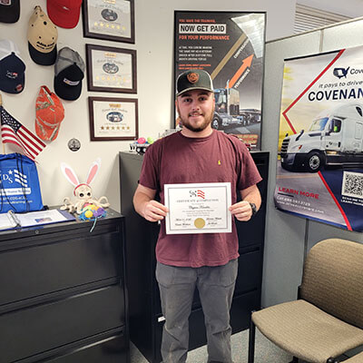 image of CDS grad, Clayton Knuckles, posing with his certificate