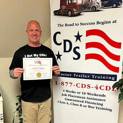 Image of CDS grad, Donald Durrette, posing with his certificate