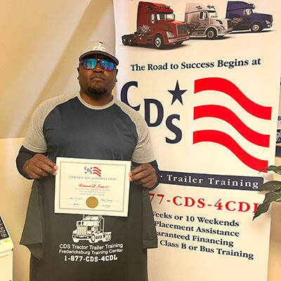 image of CDS grad, Edward Jones III, posing with his certificate and shirt