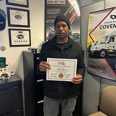 Image of CDS grad, Marvis Johnson, posing with his certificate