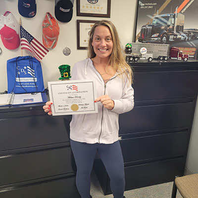 Image of CDS grad, Melissa Hornby, posing with her certificate