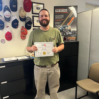 Image of CDS grad, William Frye, posing with his certificate