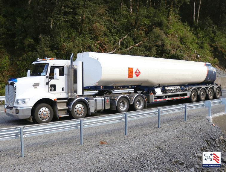 White Hazmat tanker truck parked on roadway